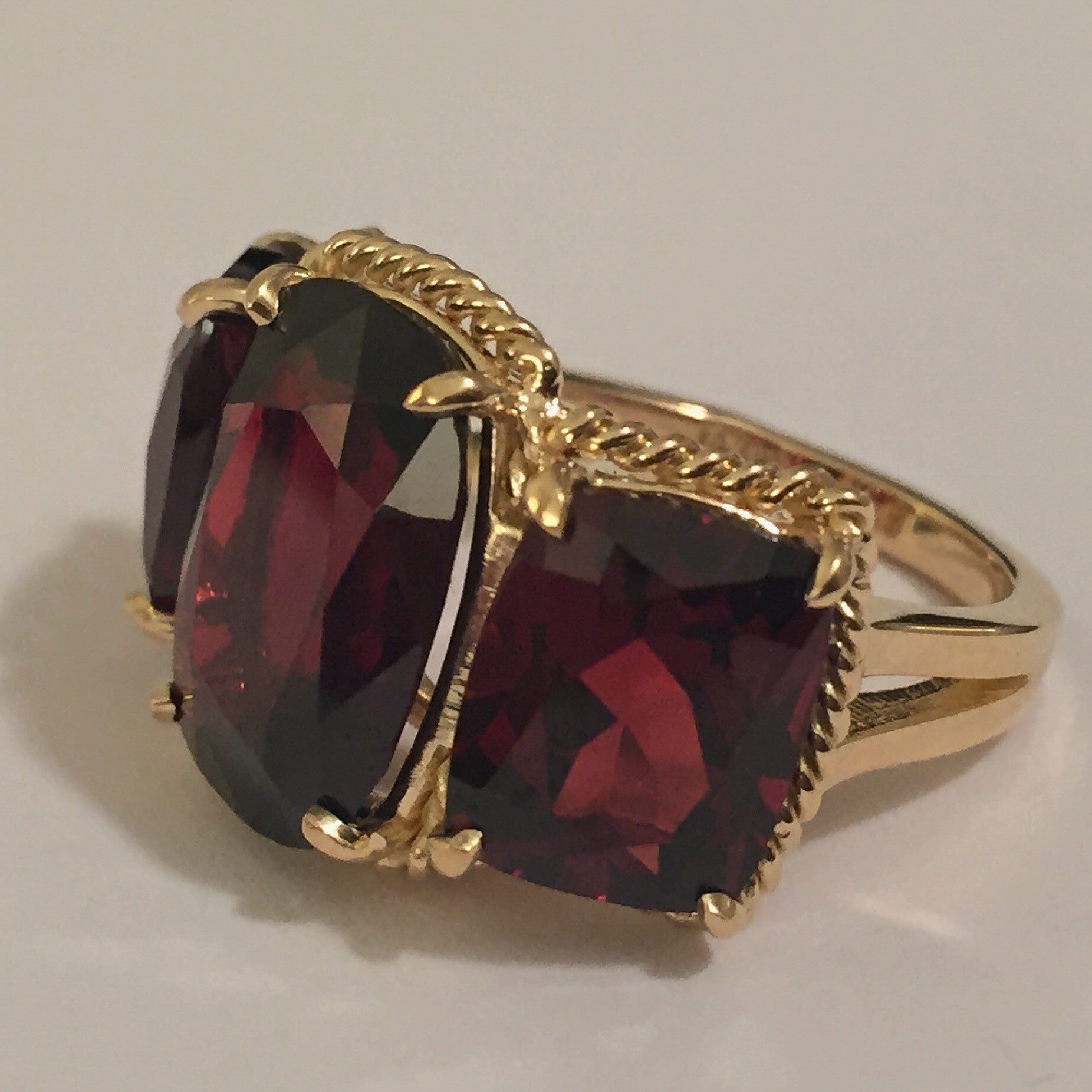 Elegant Three Stone Garnet Ring with Gold Rope Twist Border